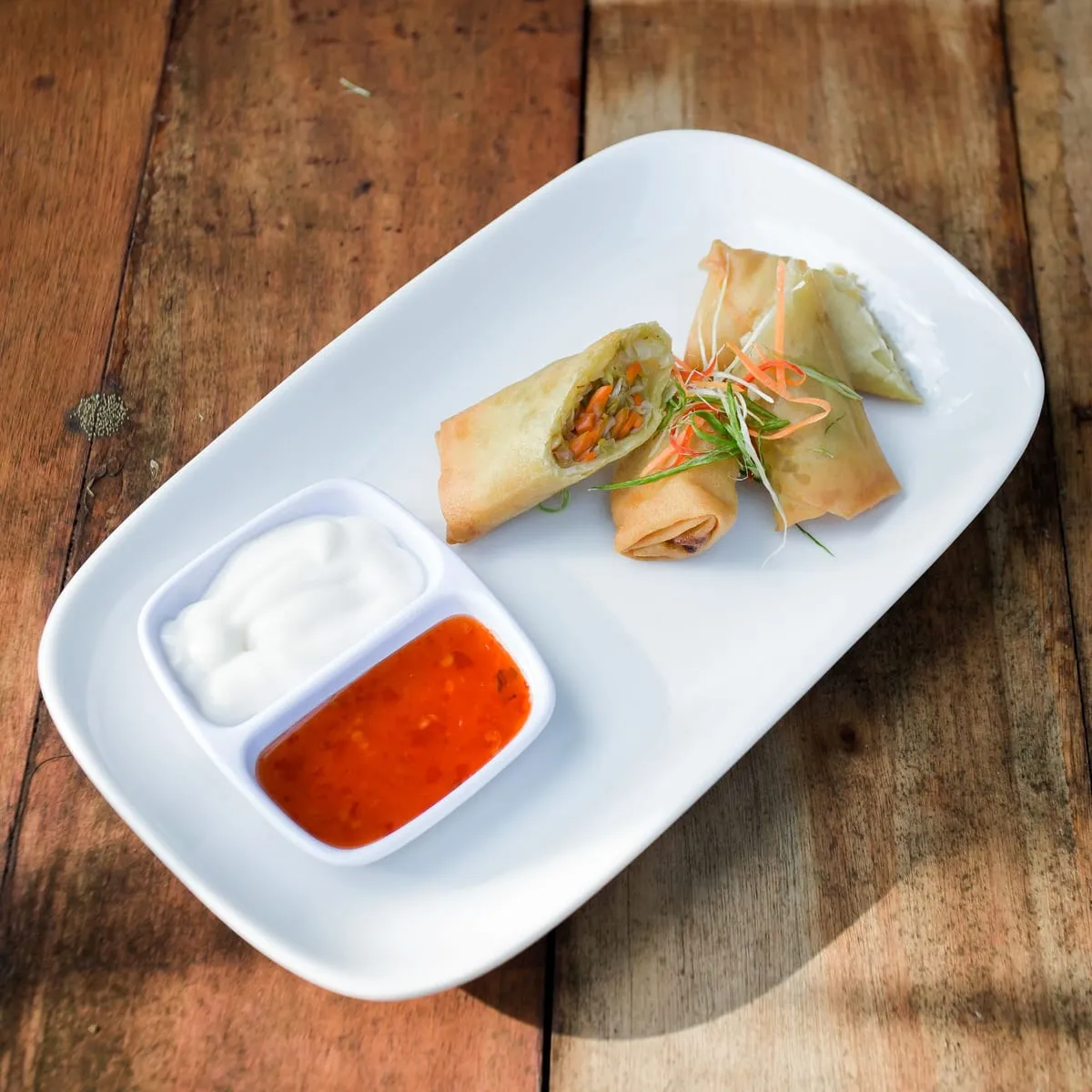Wantán frito recién preparado, servido con dos salsas